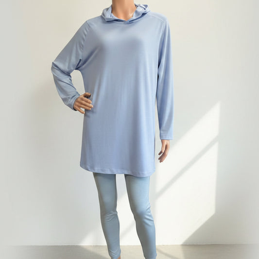 Light blue long-sleeve top and leggings on a mannequin against a plain background
