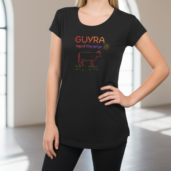 Person wearing a black t-shirt with colorful text and graphics on a neutral background