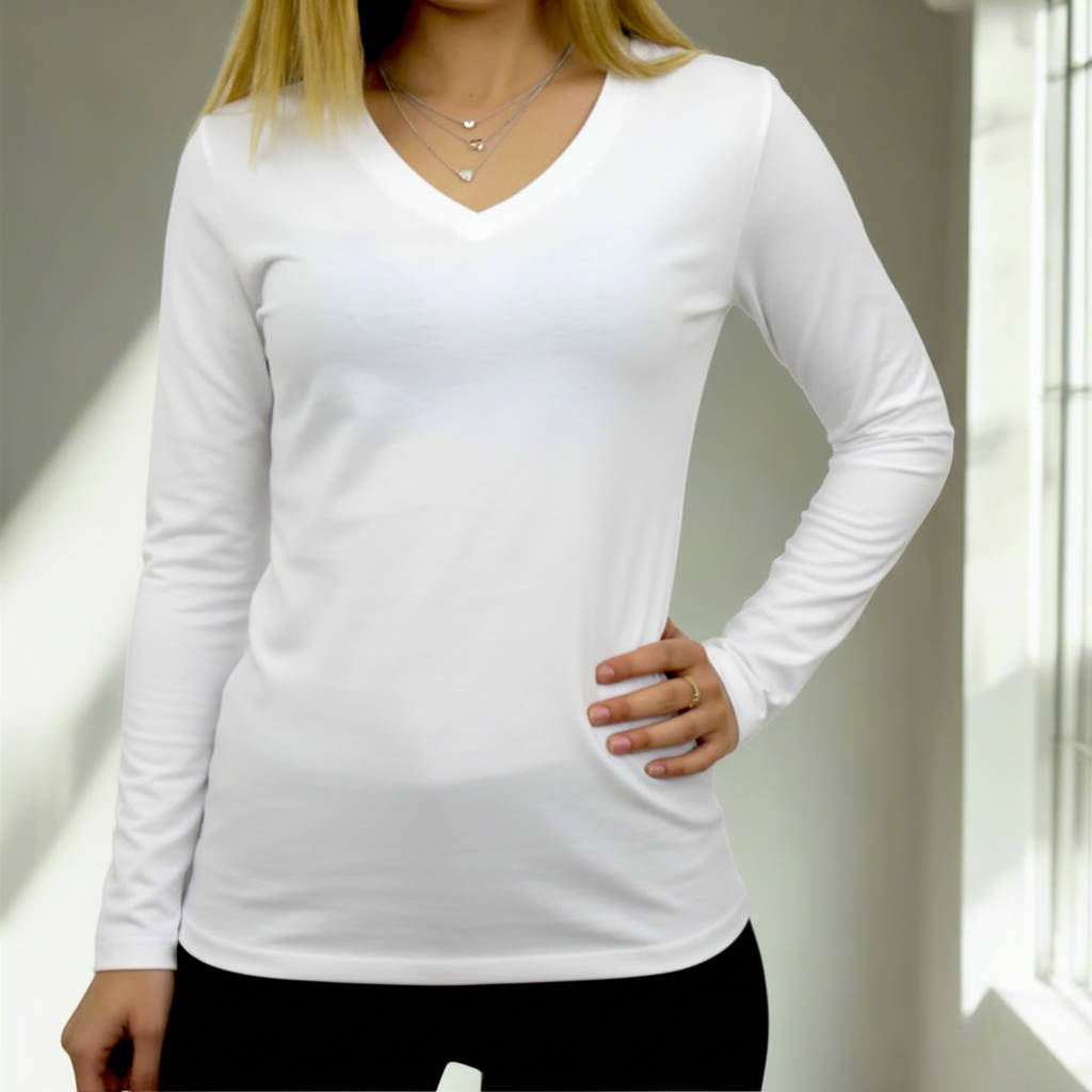 Person wearing a white long-sleeve top with a neutral background