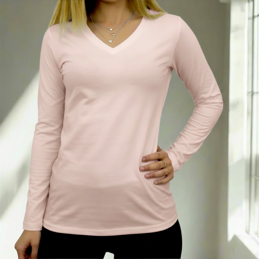 Person wearing a light pink t-shirt with a neutral background