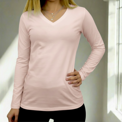 Person wearing a light pink t-shirt with a neutral background